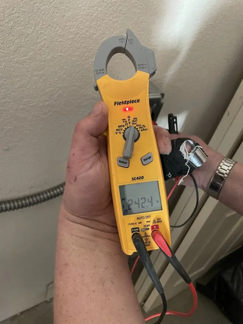 Voltage testing with clamp meter during Recessed Lighting Installation in Harvey